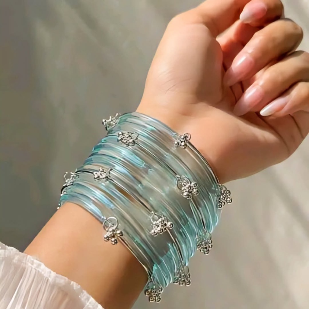 Elegance that shines with every move! These dreamy ice-blue charm bangles are the perfect blend of grace and style. (2.2)