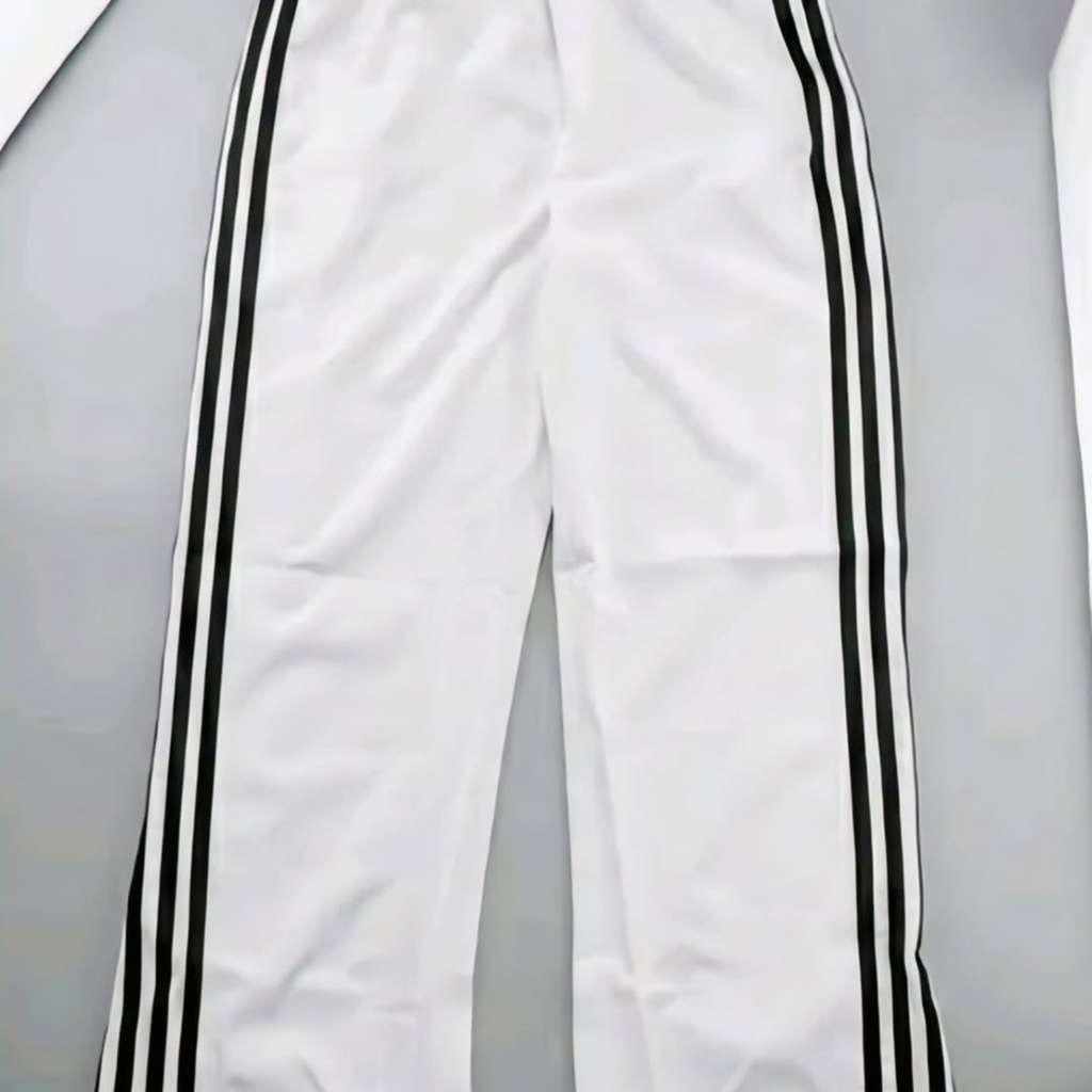 Wide - leg white track pants features three classic black sporty stripes running down both sides (S)