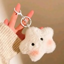 A cute, fluffy white star plush keychain with pink blushed cheeks hangs