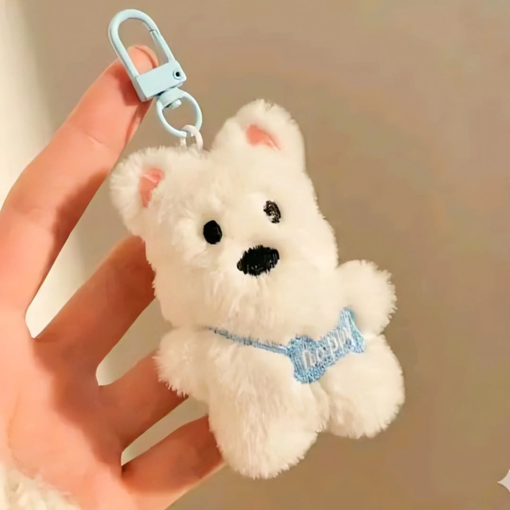 A fluffy white bear plush keychain featuring a light blue collar and a plastic clasp